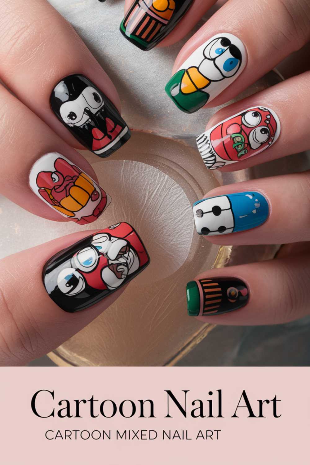 A hand flaunts vivid Cartoon Nail Art Designs, each nail adorned with intricate depictions of superheroes, robots, and animated figures. The detailed variety ensures every finger boasts a unique cartoon theme. Aptly titled Cartoon Mixed Nail Art.