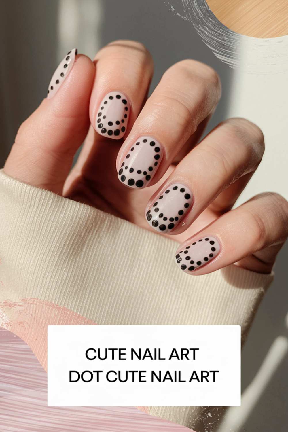 A hand with short nails painted in a minimalist design, showcasing cute nail art with small black dots outlining each nail on a natural base. The person is wearing a light beige sweater. Text reads CUTE NAIL ART DOT CUTE NAIL ART.