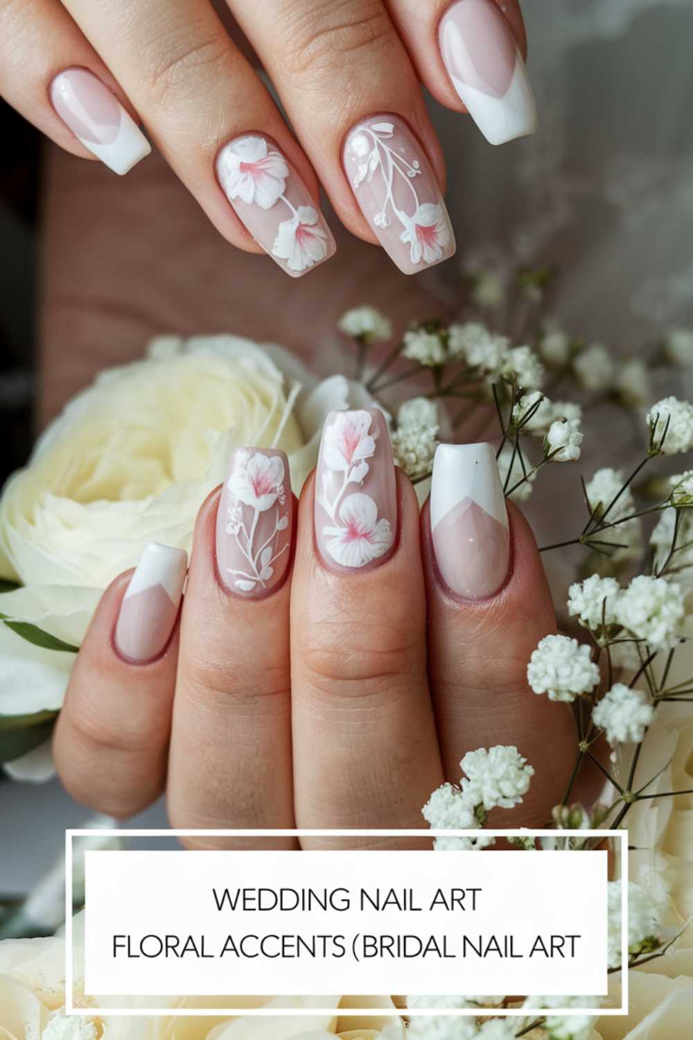Close-up of hands with manicured nails featuring bridal nail art. The design includes floral accents and French tips in pink and white. Hands hold white roses and babys breath flowers. Text at the bottom reads Wedding Nail Art Floral Accents (Bridal Nail Art).