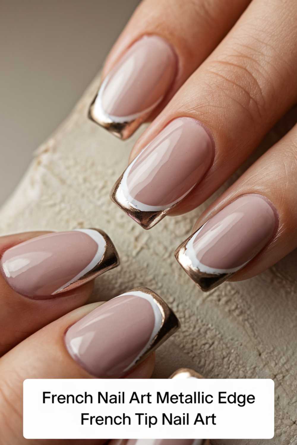 Close-up of a hand with stylish French manicure featuring metallic edges and nude polish. Nails are elegantly shaped with shiny silver tips. Text at the bottom reads: French Nail Art Metallic Edge French Tip Nail Art.