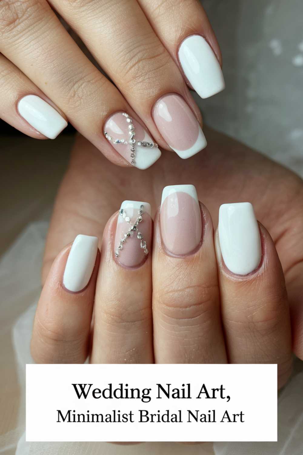 Close-up of hands showcasing minimalist bridal nail art. The nails feature a mix of white polish and nude shades with elegant silver bead accents, suitable for a wedding. Text at the bottom reads: Wedding Nail Art, Minimalist Bridal Nail Art.