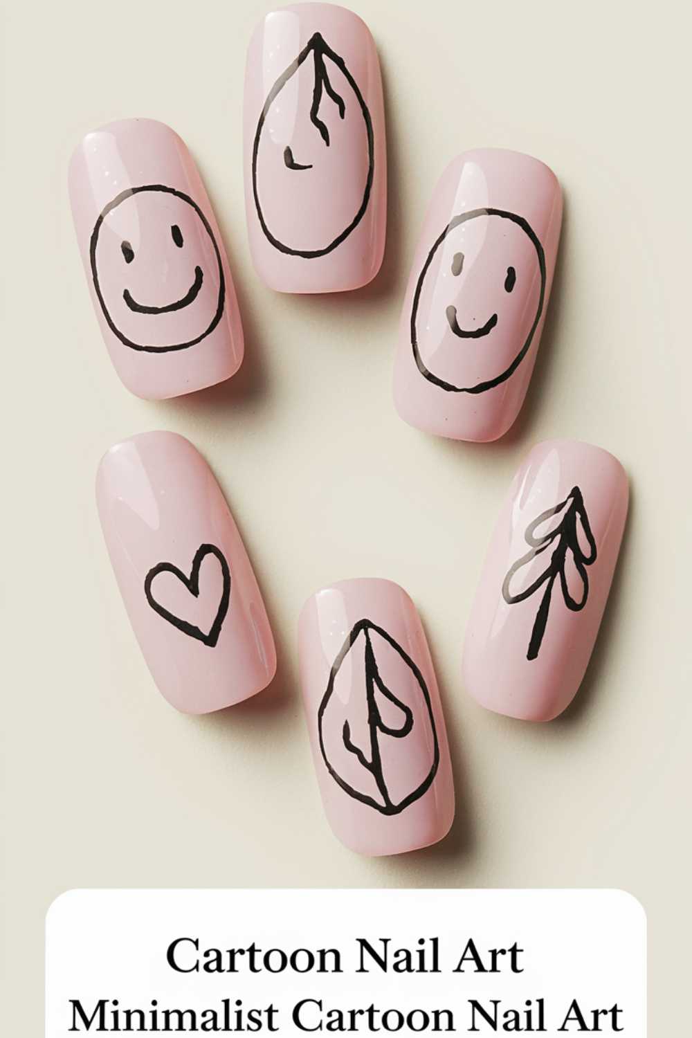 Five nails showcase minimalist cartoon nail art designs against a light pink background. Each nail features a simple black illustration: two smiley faces, two leaves, and one heart.