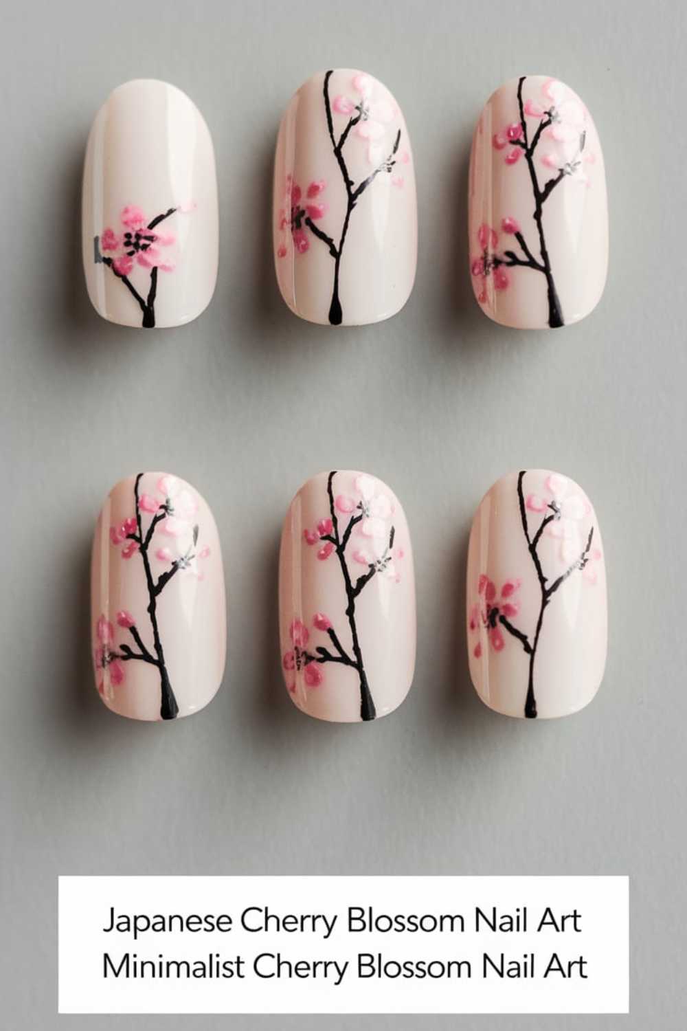 Minimalist nail art featuring branches with pink cherry blossoms on a white background. Each nail shows a black branch with delicate pink flowers, creating a harmonious and elegant look.