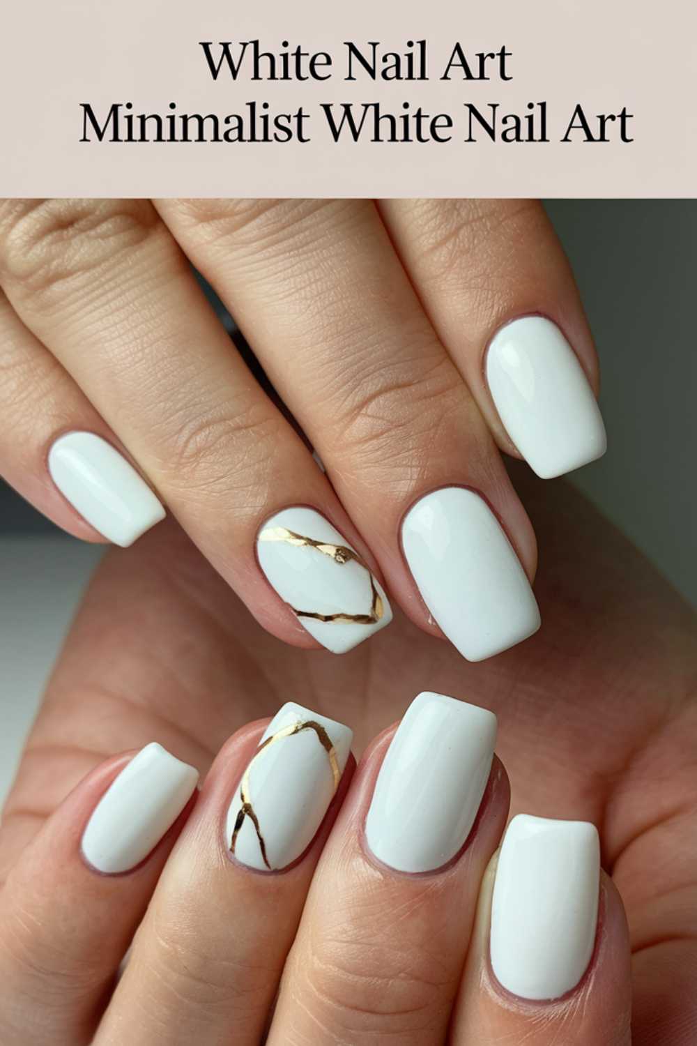 Close-up of hands displaying white square-shaped nails. Two nails feature minimalist gold marbling. Text at the top reads White Nail Art Minimalist White Nail Art.