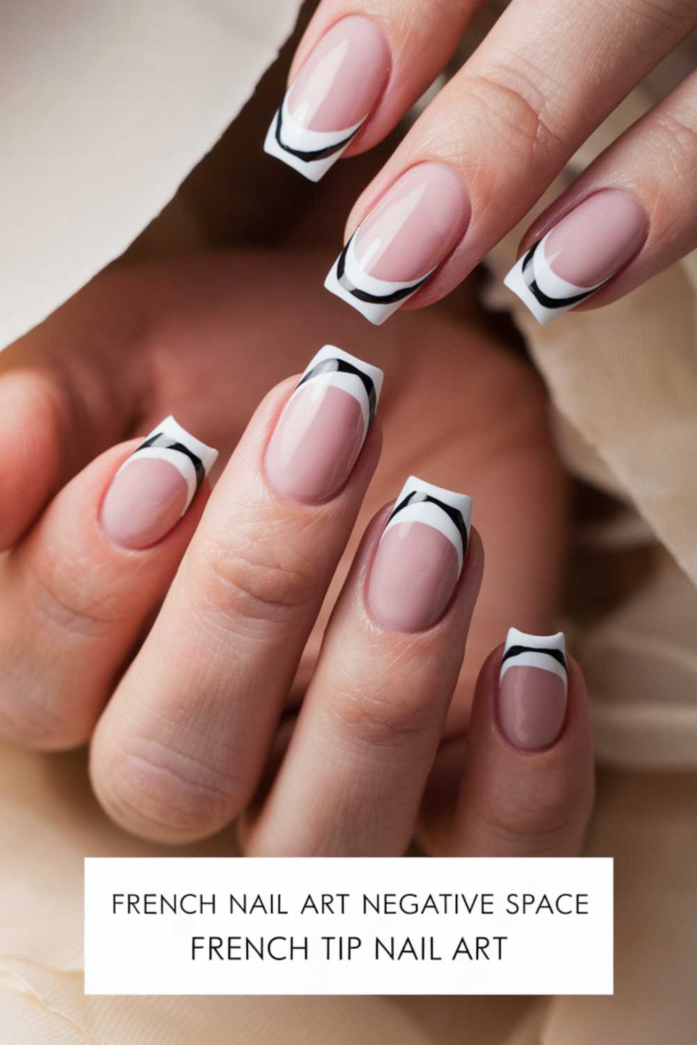 Close-up of hands with French tip nail art. Nails feature neutral polish with black and white wave patterns creating a negative space design. The text below reads: French Nail Art Negative Space, French Tip Nail Art.