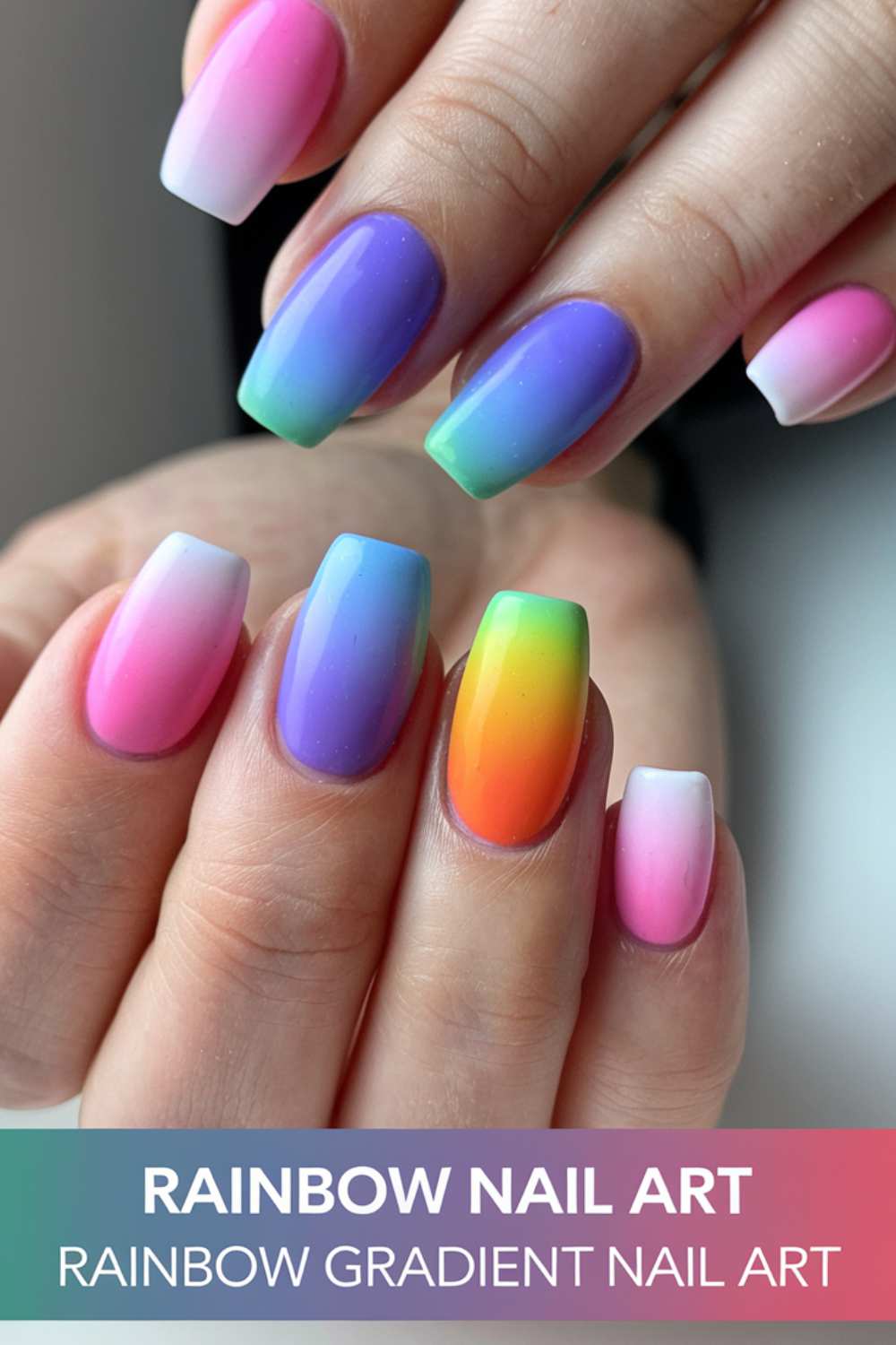 Close-up of hands showcasing stunning gradient nail art with vibrant rainbow colors, seamlessly transitioning across each nail. Featuring pink, purple, blue, and green hues with a glossy finish. Text reads: Rainbow Nail Art: Rainbow Gradient Nail Art.