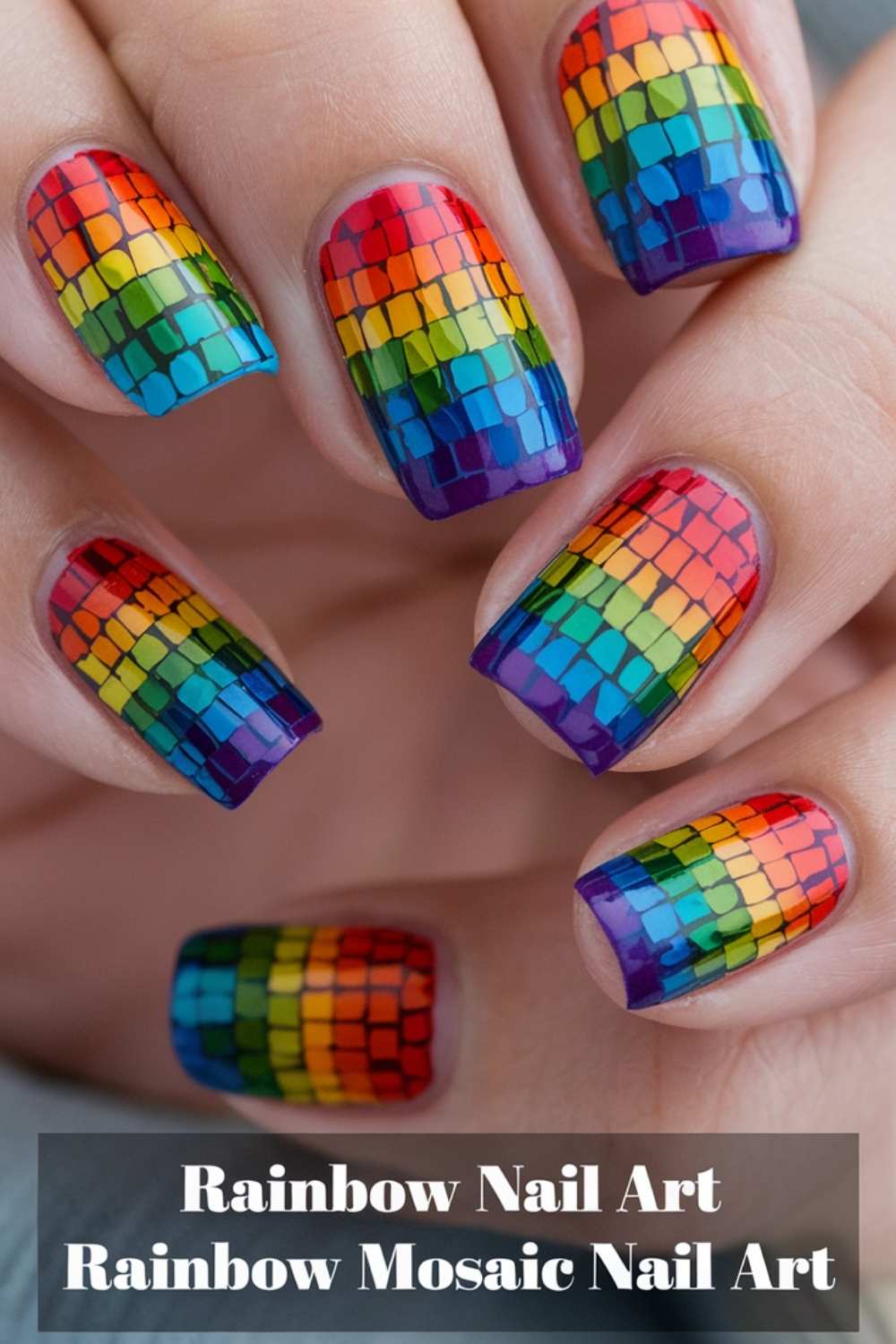 Close-up of hands showcasing rainbow mosaic nail art, where each nail flaunts a vibrant, tiled pattern in rainbow hues. Vibrant and eye-catching, this Rainbow Nail Art is a true testament to colorful creativity.