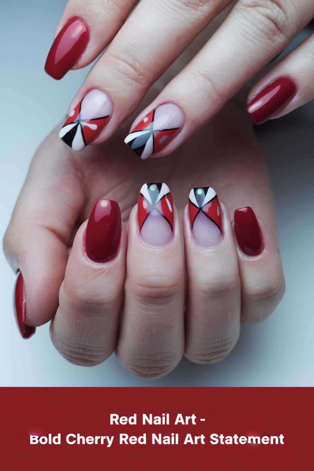Close-up of hands with a stylish cherry red manicure. The middle and ring fingers feature geometric nail art in red, black, white, and nude tones. Background text reads: Red Nail Art - Bold Cherry Red Nail Art Statement.