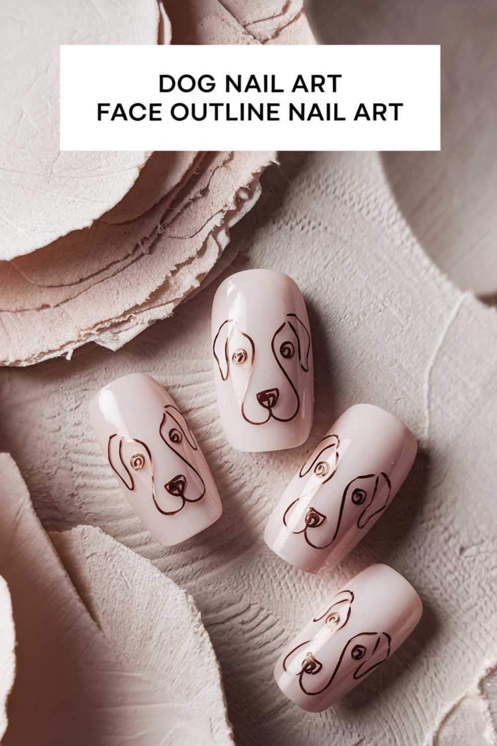 Four artificial nails boast simple black outlines of dog faces on a pale pink background, perfectly capturing the essence of Dog Nail Art. They rest elegantly on textured beige paper, beneath text that reads Face Outline Nail Art.