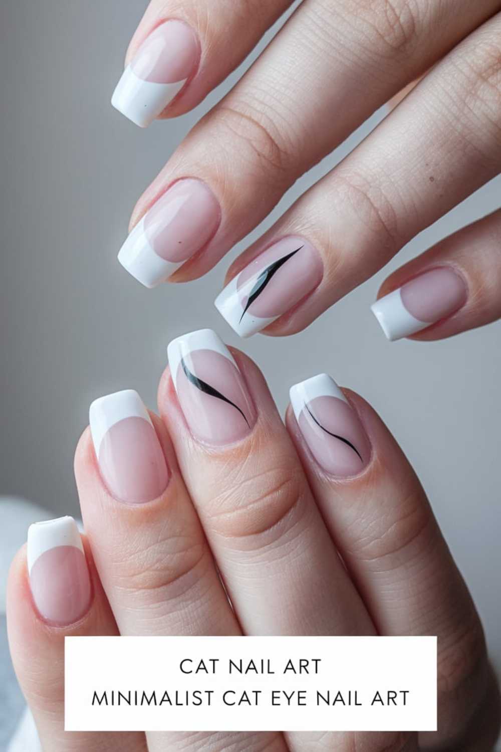 Close-up of a hand with nails painted in a minimalist style. Most nails have white French tips, while two feature a sleek black cat eye design. Text reads: Cat Nail Art, Minimalist Cat Eye Nail Art.