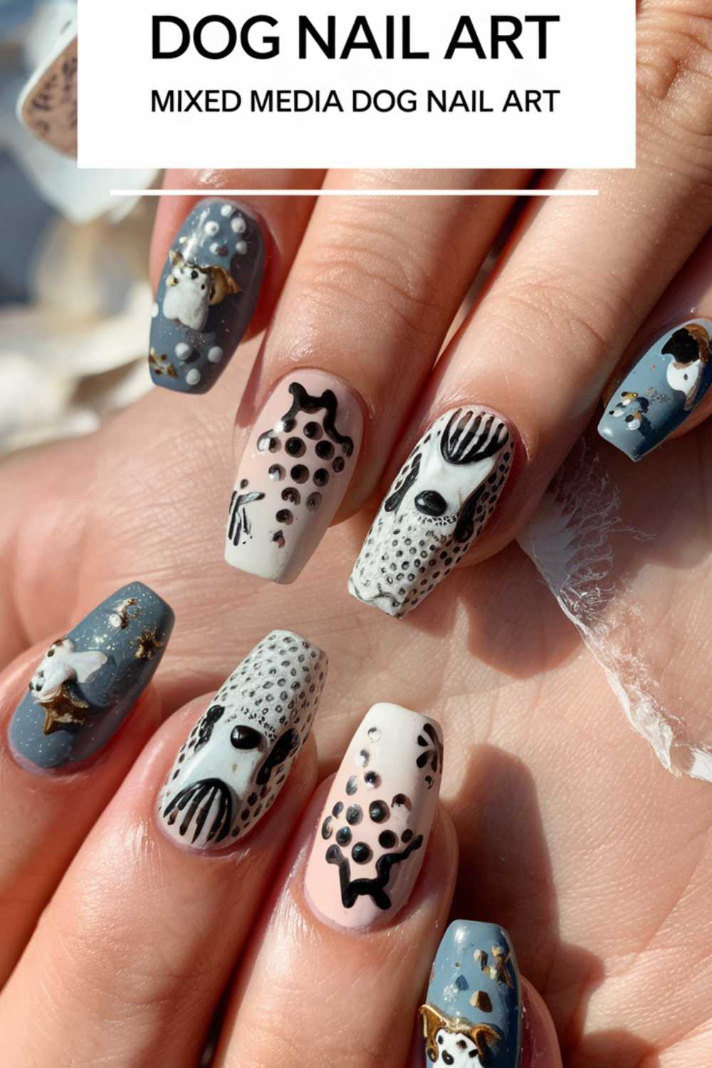 A close-up showcases exquisite dog-themed nail art on pastel-toned nails in grey, beige, and cream. Each features intricate black and white canine designs with decorative accents. Above, the text reads: Dog Nail Art: Mixed Media Innovation.