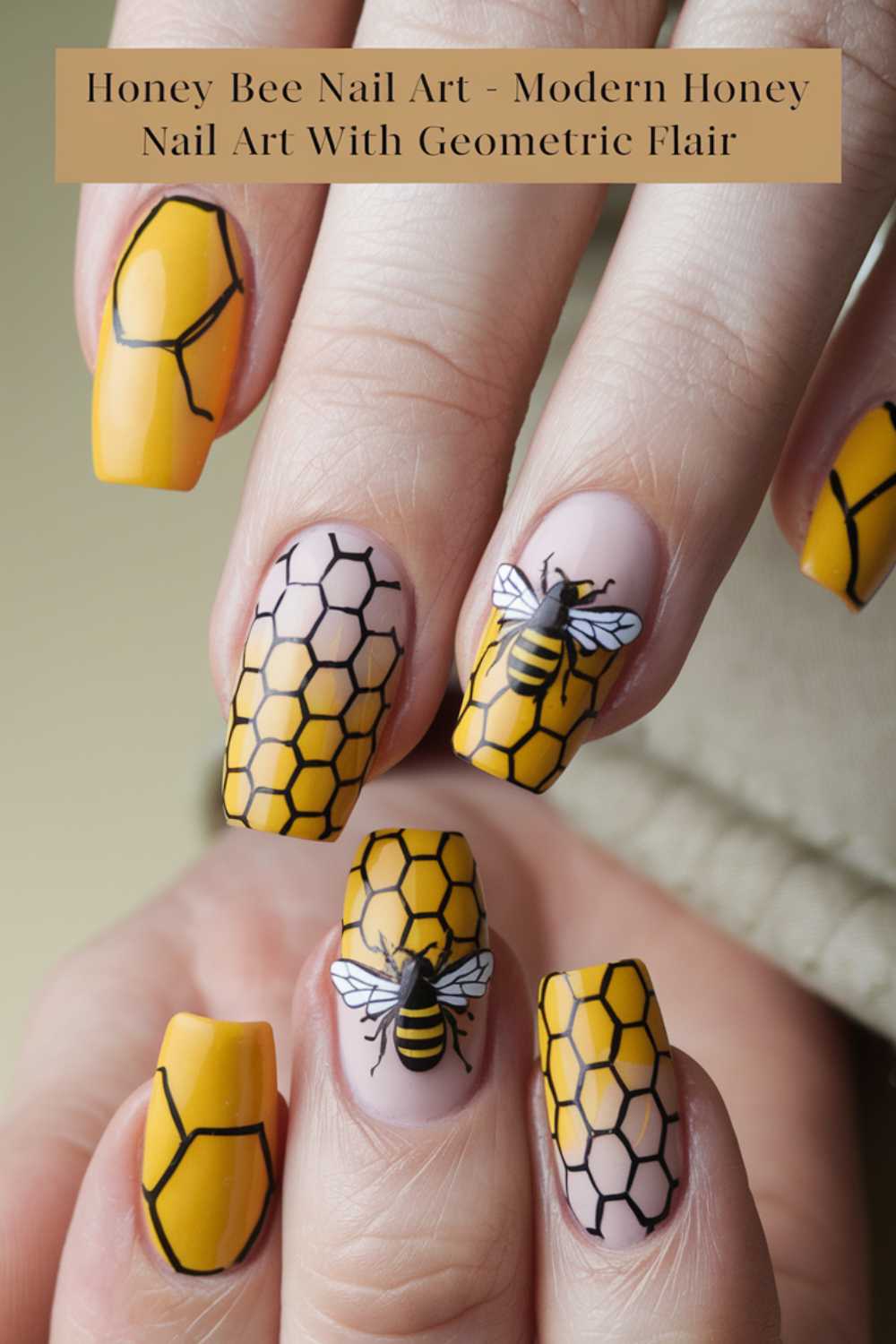 Close-up of hands showcasing bee nail art. Nails feature yellow and nude tones with black honeycomb patterns and detailed bee illustrations. Text at the top reads, Honey Bee Nail Art - Modern Bee Nail Art With Geometric Flair.