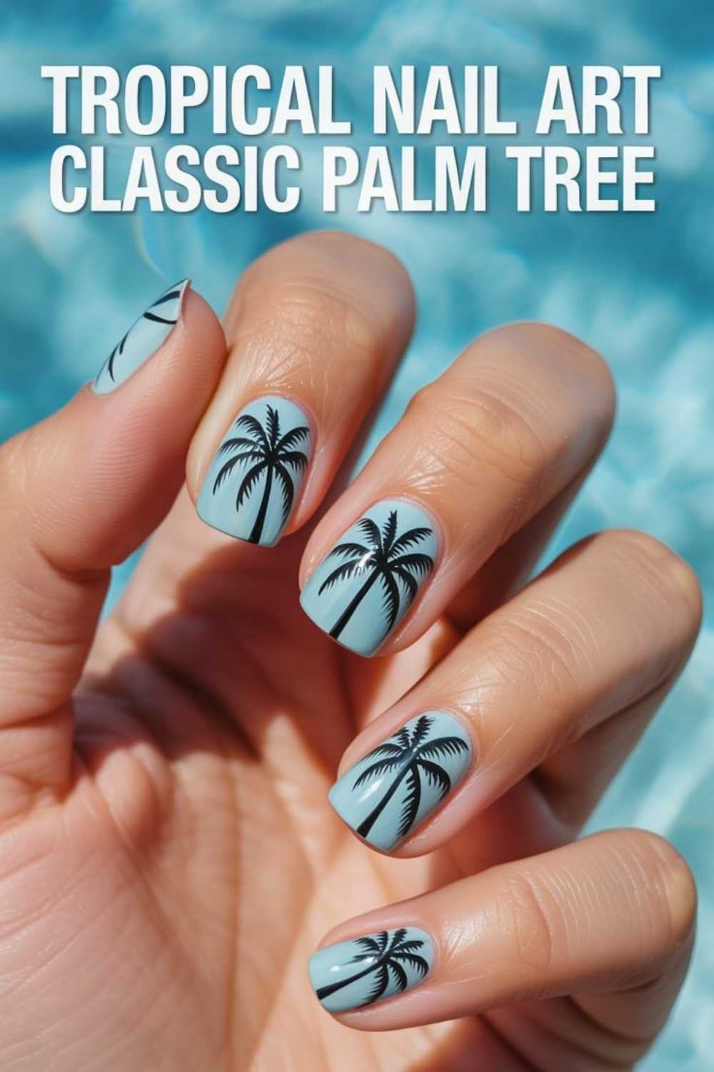 A hand with light blue nails features black palm tree designs on each nail. The background is blurred blue, resembling water. Text at the top reads: Tropical Nail Art Classic Palm Tree.