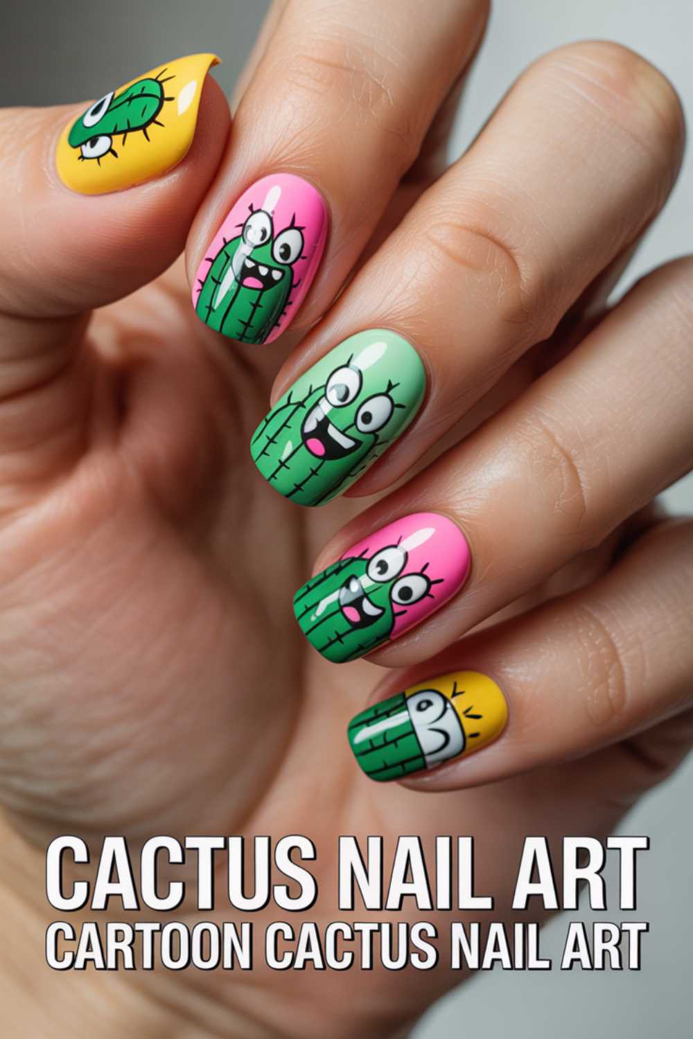 A hand with brightly colored nails featuring cartoon cactus faces on each nail. The designs are playful and expressive, with various shades of green, pink, and yellow backgrounds. Text reads: CACTUS NAIL ART. CARTOON CACTUS NAIL ART.