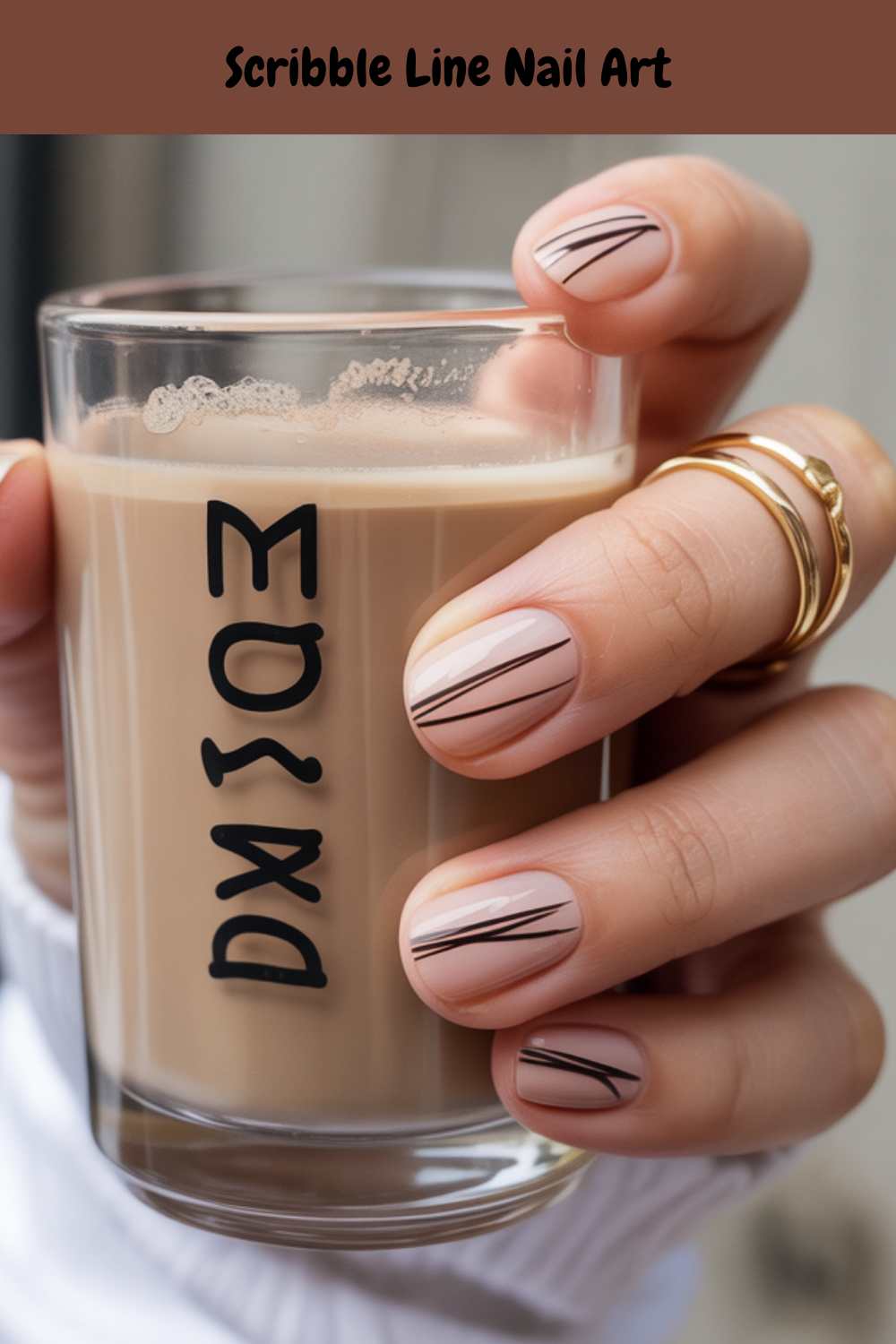A hand with minimalist scribble line nail art holds a glass of coffee with black lettering. The person wears gold rings and a white sleeve. The text Scribble Line Nail Art appears at the top of the image.