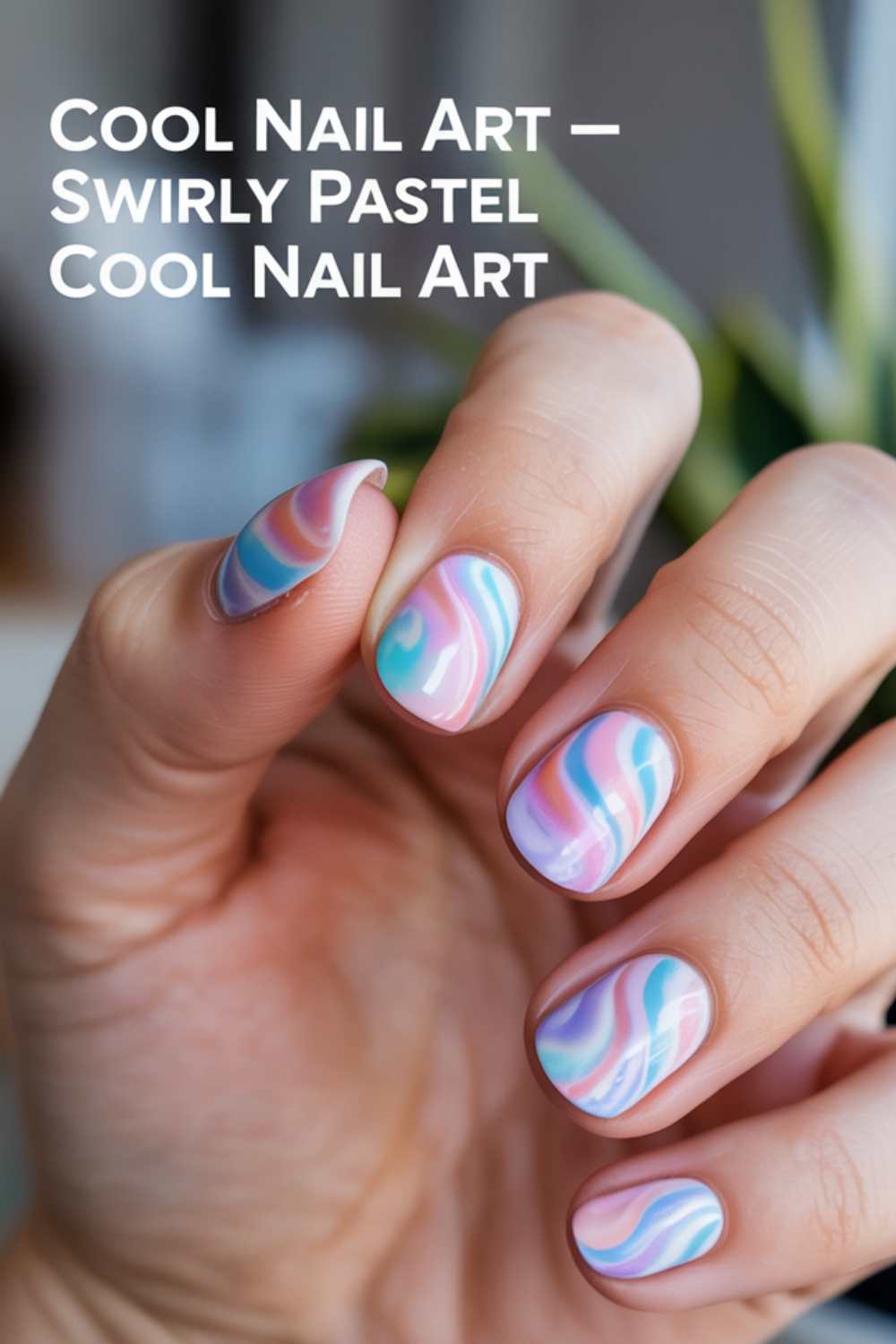 A hand with neatly manicured nails featuring swirly pastel nail art in shades of pink, blue, and teal. The text reads “Cool Nail Art — Swirly Pastel Cool Nail Art.”.